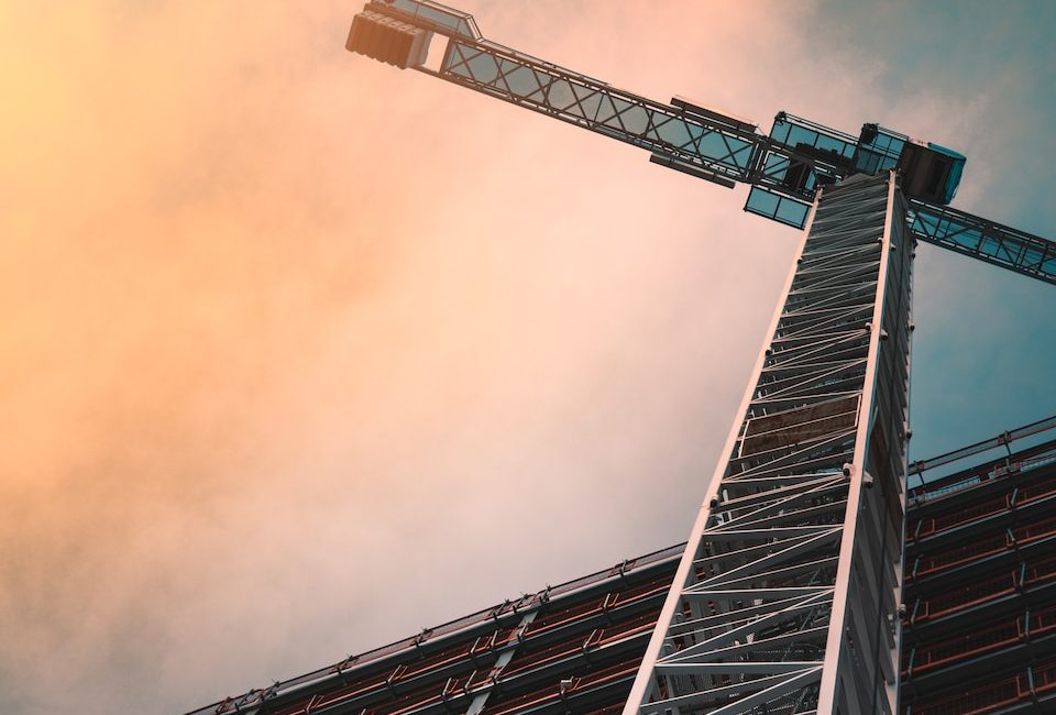 low angle photography of gray tower crane