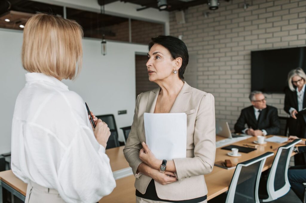 Two colleagues discussing pay strategy during a business meeting