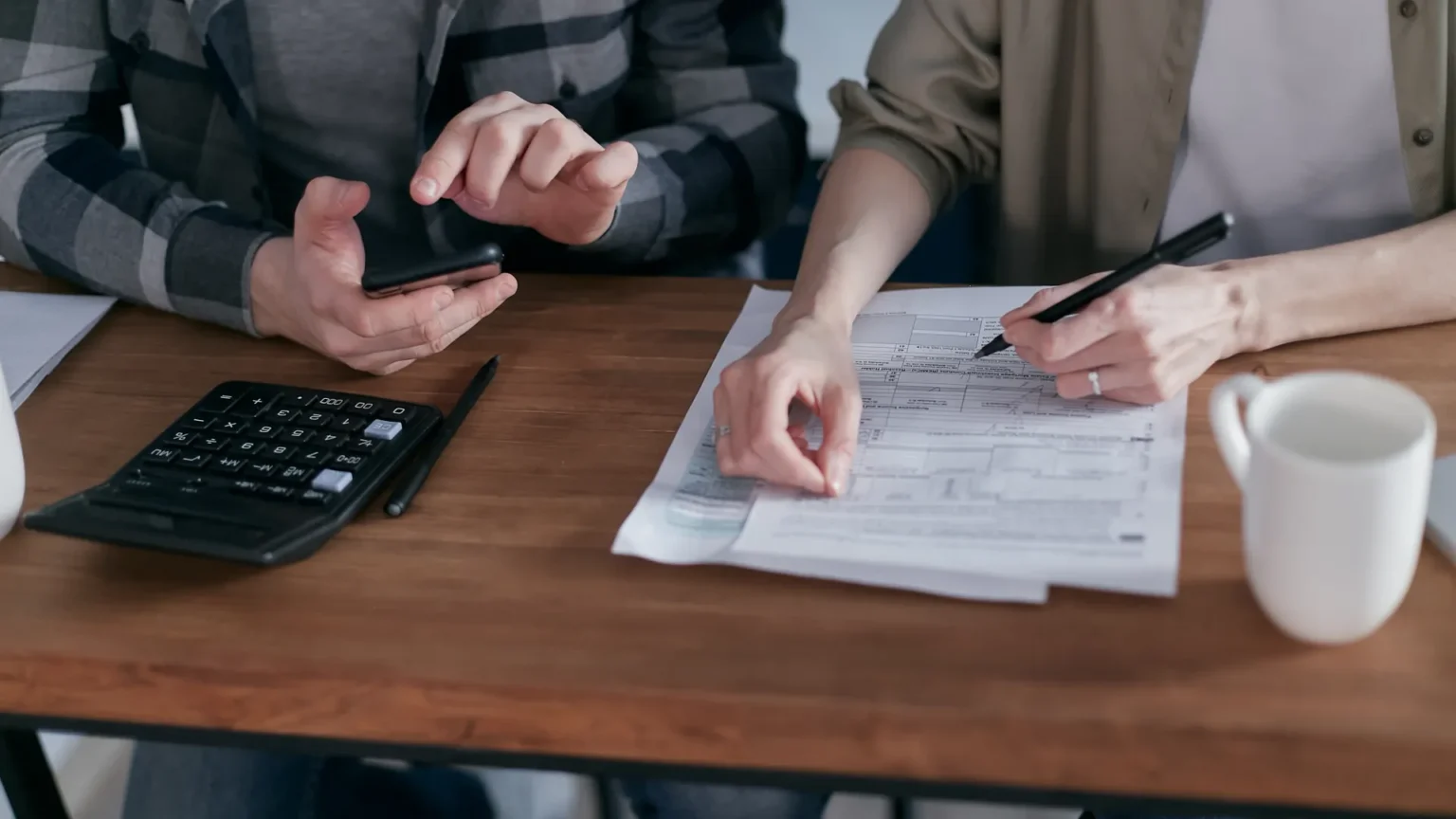 Carlsbad Households: Why Tax Planning Should Not Wait Until April Couple reviewing household tax forms with a calculator